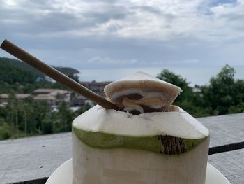 Close-up of cake on wooden table against sky