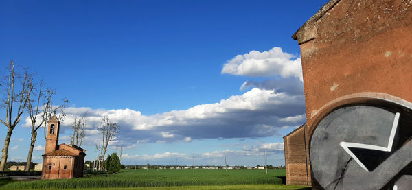 Built structure on field against sky