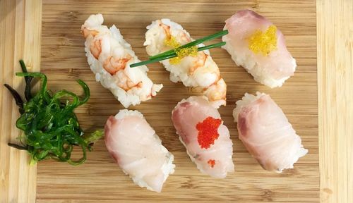 High angle view of sushi served on cutting board