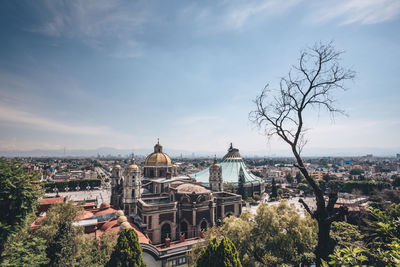 High angle view of trees and buildings against sky