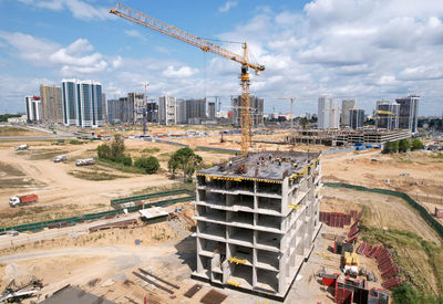 Panoramic view of construction site against buildings in city