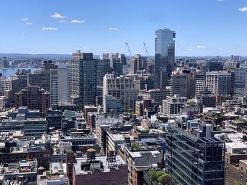 High angle view of modern buildings in city against sky