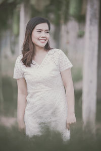 Portrait of a smiling young woman standing outdoors