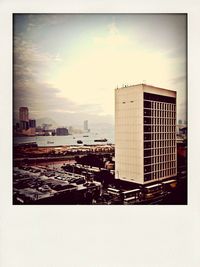 Buildings against cloudy sky