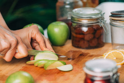 Cutting apple and lemon in the kitchen. fruit fermentation.