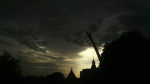 Low angle view of silhouette building against sky at sunset