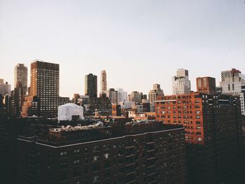Modern buildings in city against clear sky