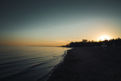 Scenic view of beach against sky during sunset