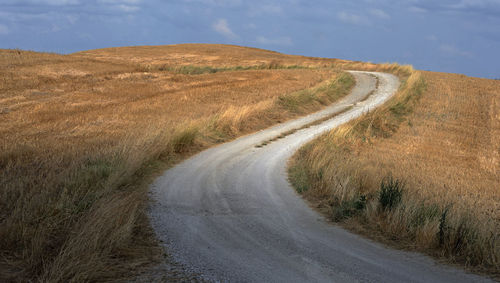 Dirt road passing through landscape