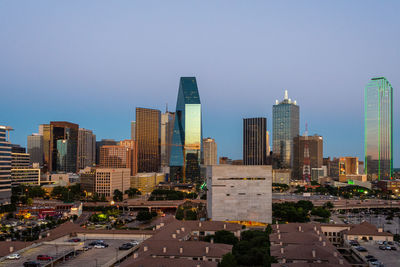 Modern buildings in city against clear sky