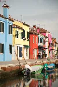 Houses by swimming pool in city against sky