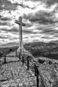 Cross in temple against sky