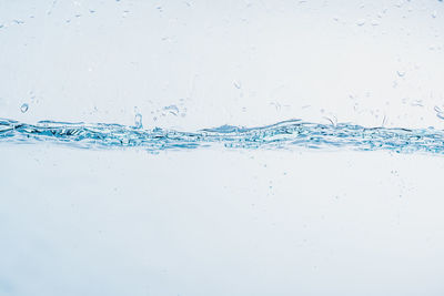 Close-up of water splashing against blue background