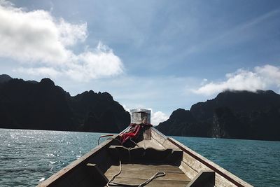 Scenic view of sea by mountains against sky