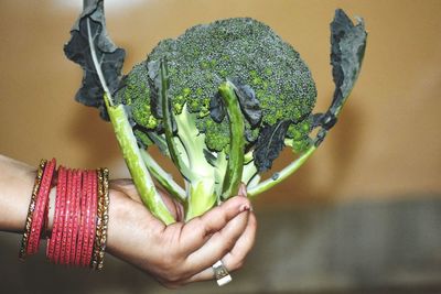 Close-up of woman holding broccoli