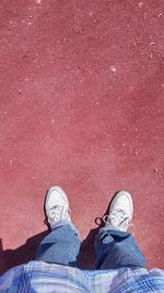 Low section of woman standing on tiled floor