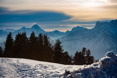 Scenic view of snowcapped mountains against sky during sunset