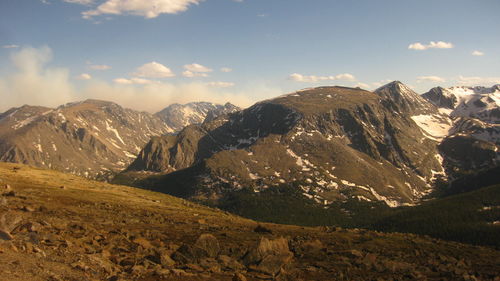 Scenic view of mountains against cloudy sky