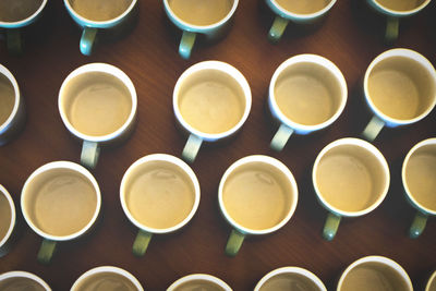 Full frame shot of coffee cups arranged on table