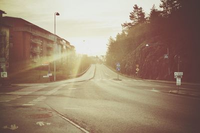 Empty road along trees