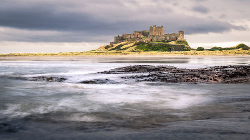 Bamburgh castle is on the northeast coast of england, by the village of bamburgh in northumberland.