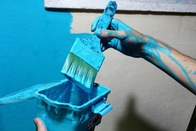 Close-up of man holding multi colored brush