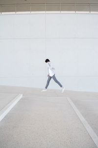 Full length of man skateboarding on wall