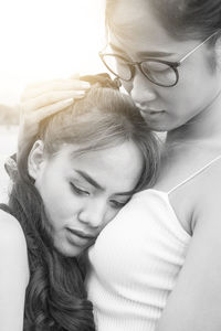 Close-up of young lesbian couple hugging outdoors