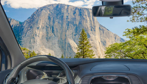 Scenic view of mountains seen through car windshield