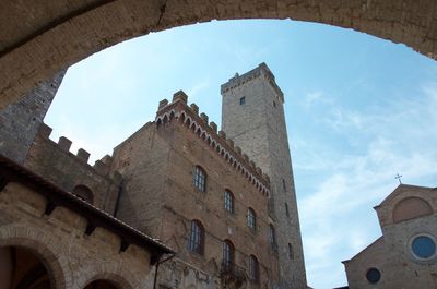 Low angle view of building against cloudy sky