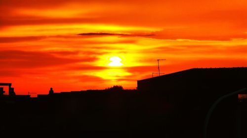 Silhouette of built structure against dramatic sky