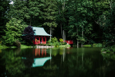 Lake by gazebo and trees at park