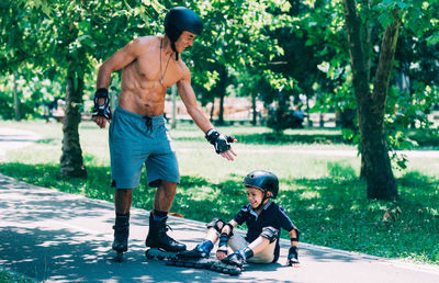 Full length of father and son on tree