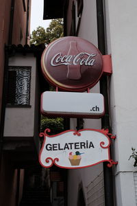 Low angle view of road sign against building