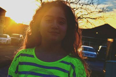 Portrait of teenage girl on street during sunset