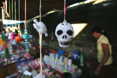 Close-up of various souvenirs hanging at shop