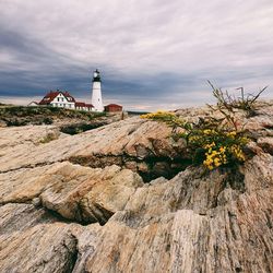 Lighthouse against cloudy sky