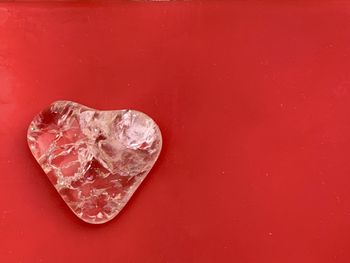 High angle view of ice cream on red surface