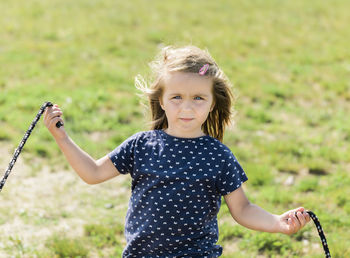 Portrait of cute girl playing on field