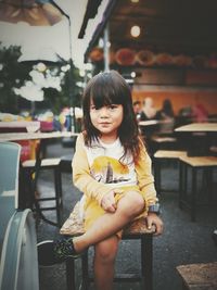 Portrait of girl sitting on chair