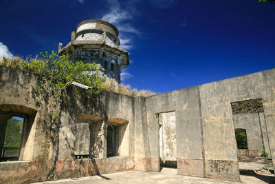 Low angle view of built structure against blue sky