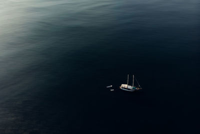 From above of various modern motor boats floating on calm surface of sea during sunny day