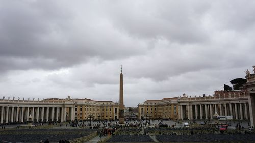 Buildings against cloudy sky