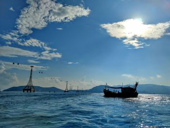 Sailboat sailing on sea against sky