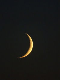 Low angle view of half moon against sky at night
