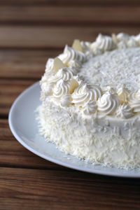 Close-up of white cake served on table