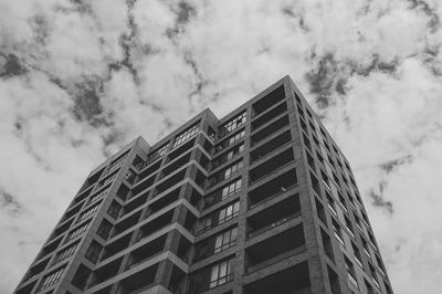 Low angle view of building against cloudy sky