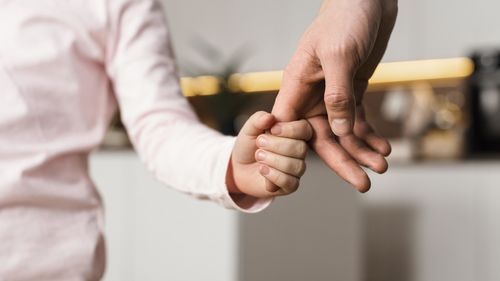 Midsection of man holding hands