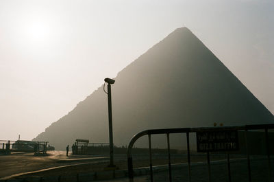 Sign on barricade with pyramid in background