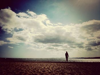 Silhouette of woman standing on beach